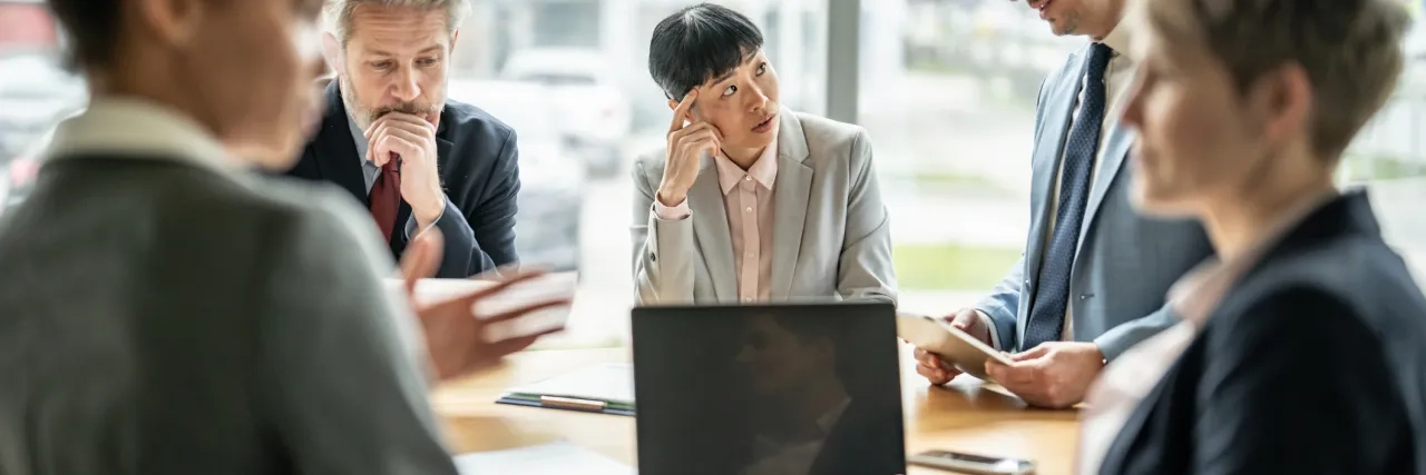 Multi-ethnic businesspeople brainstorming new ideas and collaborating in conference room