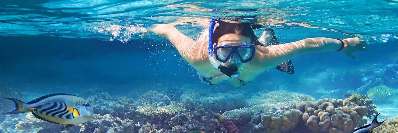 Woman snorkeling in the tropical waters of the Caribbean