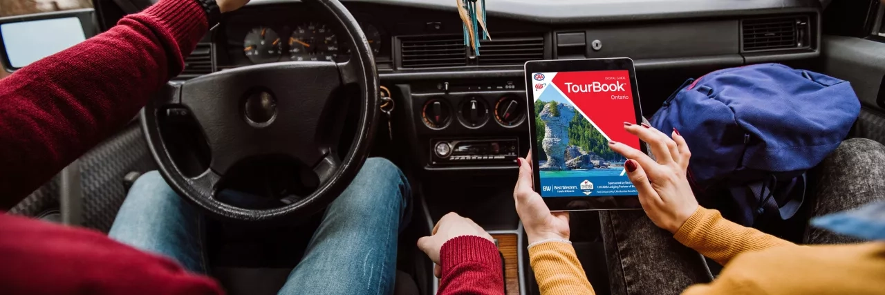 Woman viewing an Ontario TourBook on her tablet 