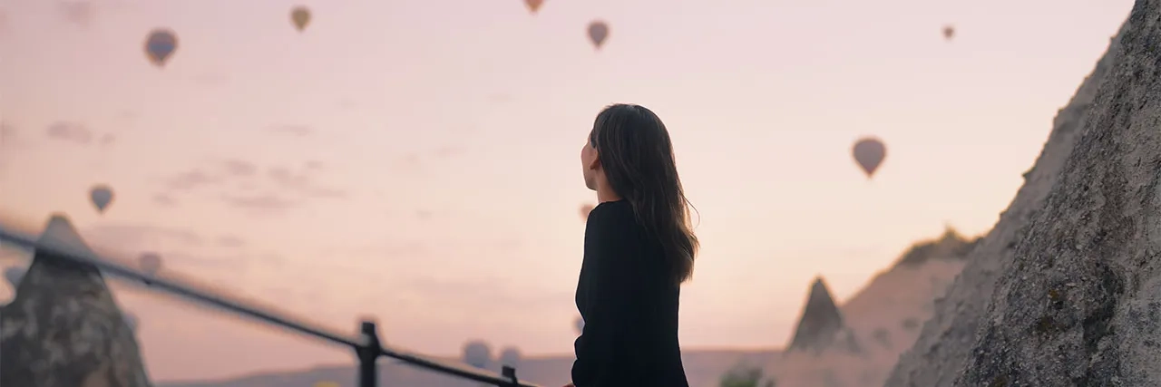 female tourist watching air ballon