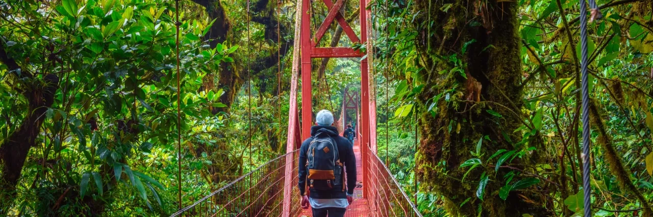 Tourist walking on a suspension bridge in Monteverde Cloud Forest, Costa Rica