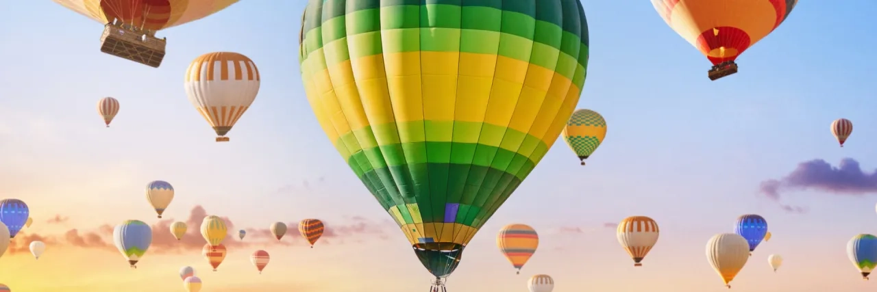 Landscape of fabulous Kapadokya. Colorful flying air balloons in sky at sunrise in Anatolia. Vacations in beautiful destination in Goreme, Turkey