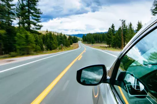 View of car driving on right side of road