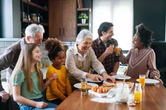 Grandparents hosting family dinner with the grandkids and parents