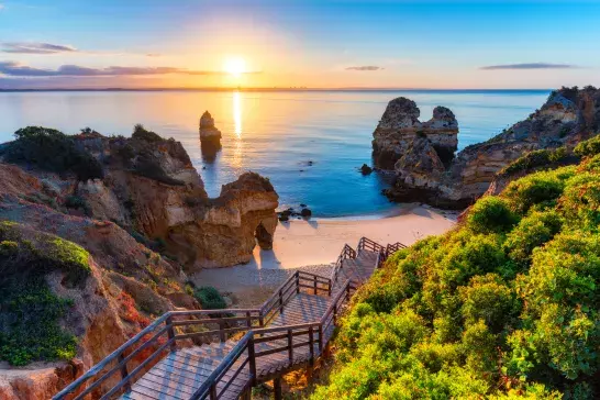 A staircase heading to the beach at sunset in the Algarve Coast, Portugal. 