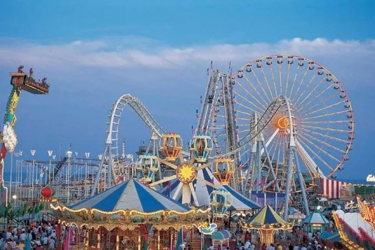 A vibrant amusement park featuring a Ferris wheel, roller coasters, and other rides, capturing the excitement and joy of a day filled with entertainment.