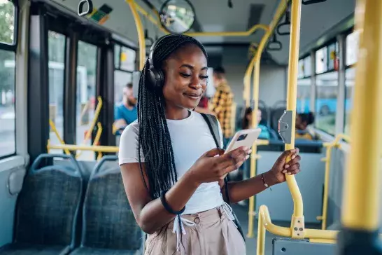 African-american-woman-using-smartphone-while-riding-a-bus