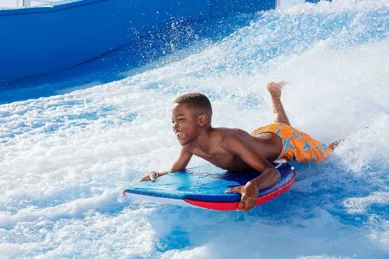 Boy playing on Royal Caribbean Cruise's Flow Rider