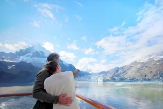 Couple onboard Holland America Line Alaska cruise looking at the horizon
