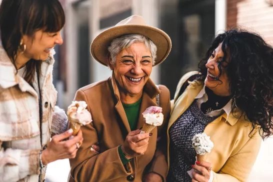 Group of women travellers eating gelato in Italy