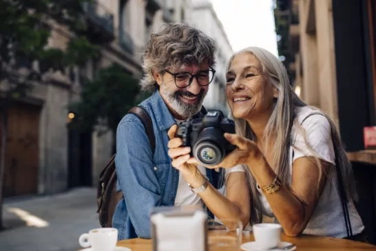 Mature couple on holiday in Europe taking photos