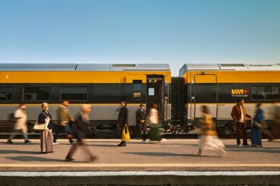 People walking alongside a VIA Rail train