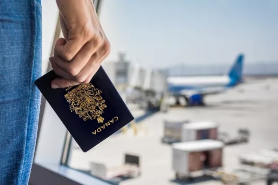 Person holding a Canadian passport at the airport