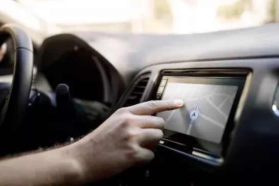 Person using GPS in car rental