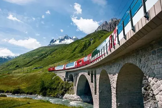 The Glacier Express train running over a bridge. 