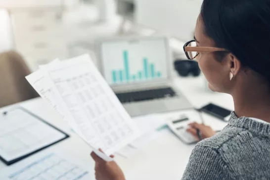 Woman reviewing data and analytics report