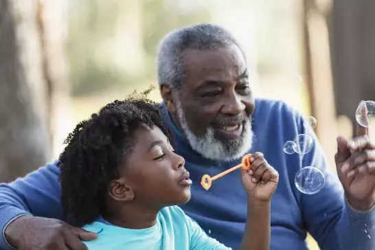 Dad and son blowing bubbles together