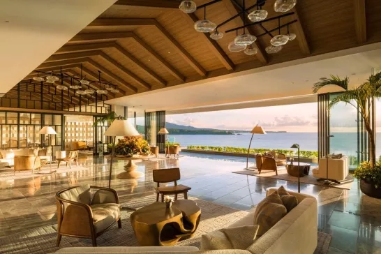 An elegant resort lounge with panoramic views of the ocean, blending luxury with relaxation in a serene, tropical setting.