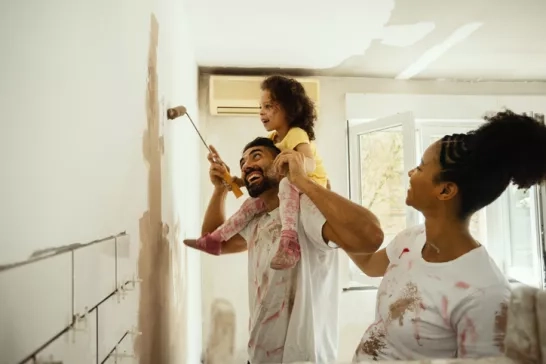 Young family paints walls during home renovation