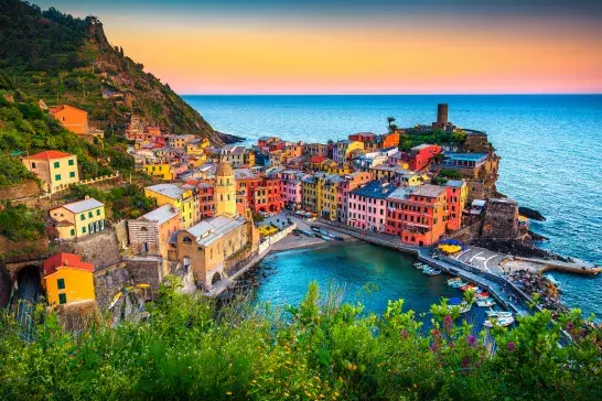 Colourful buildings along the coastline at sunset in Cinque Terre, Italy