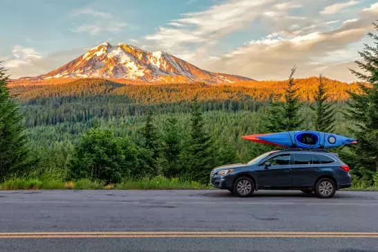 Gifford Pinchot National Forest, Washington - July 13, 2018: SUV with Kayaks in front of Mt. Adams at sunset