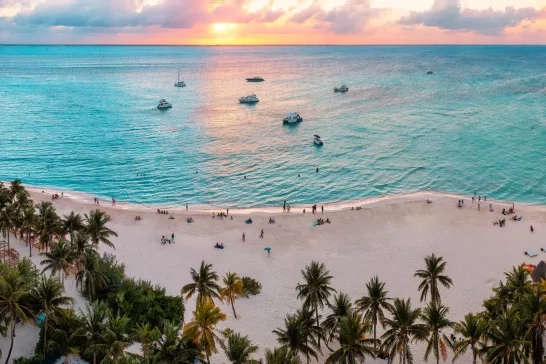 Sunset over a white sandy beach in Cancun, Mexico