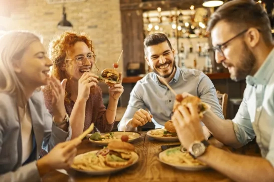 Friends eating meal at restaurant