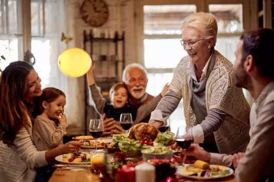 multi generational family eating dinner together