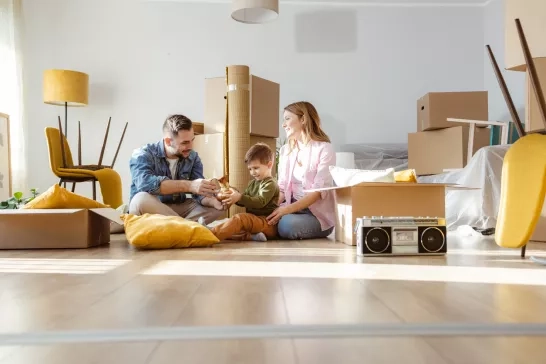 Young family unpacks boxes after moving to new home