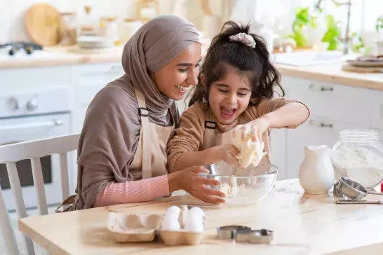 Mother and daughter baking bread together