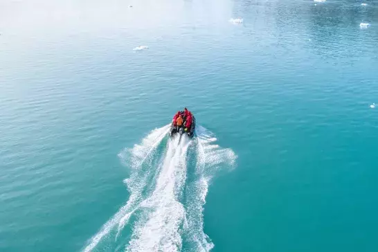 Passengers on a small boat cruising through Antarctic glaciers.