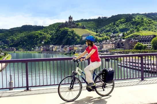 An AmaWaterways guest biking across a bridge in France.