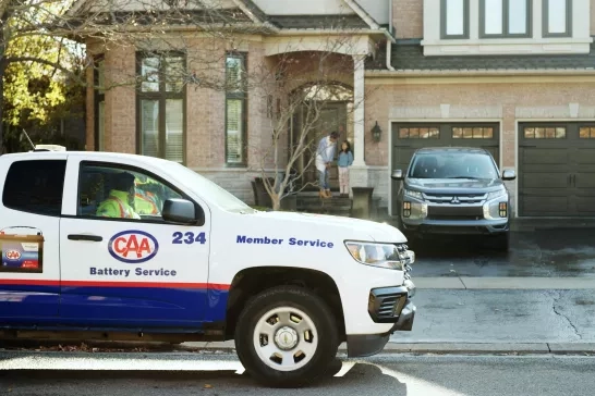CAA technician parked in front of a house 