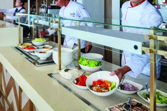 Stews onboard a Viking serving a breakfast buffet.