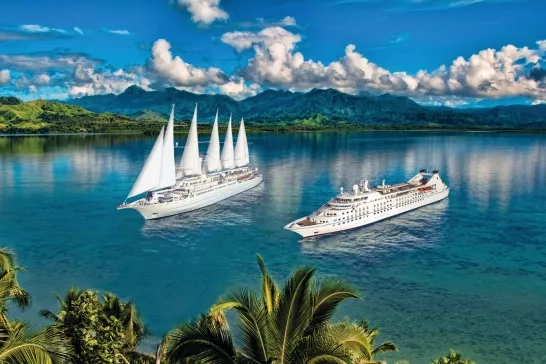 Windstar Star and Wind ships side by side in the sea.