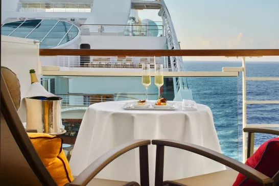 A lovely table setup on a balcony in a stateroom onboard a Seabourn Cruise.