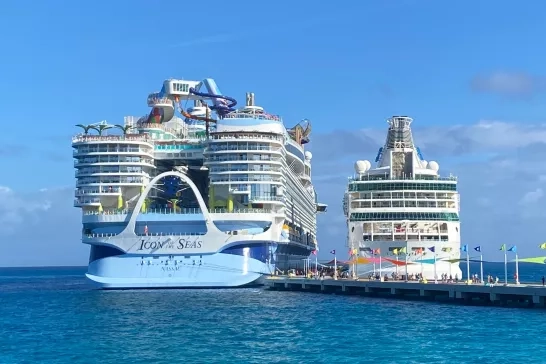 two cruise ships docked at port including Royal Carribean's new Icon of the seas