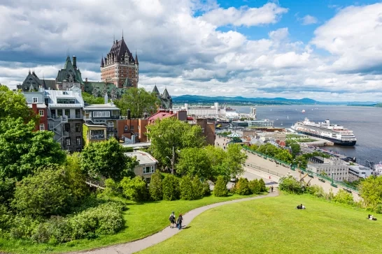 The frontenac castle and the St. Lawrence river with a cruise ship at the harbor in the Quebec city