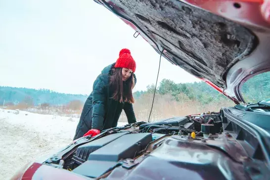 Woman looking at car engine