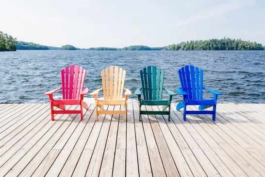 Row of multicolored Summer chairs summertime