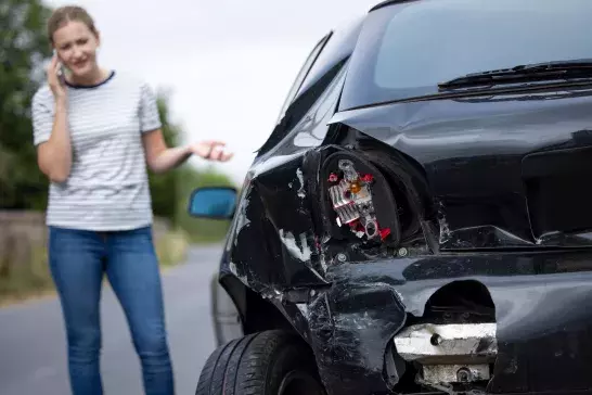 Female Driver With Damaged Car After Accident