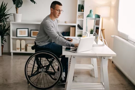 man in wheelchair working