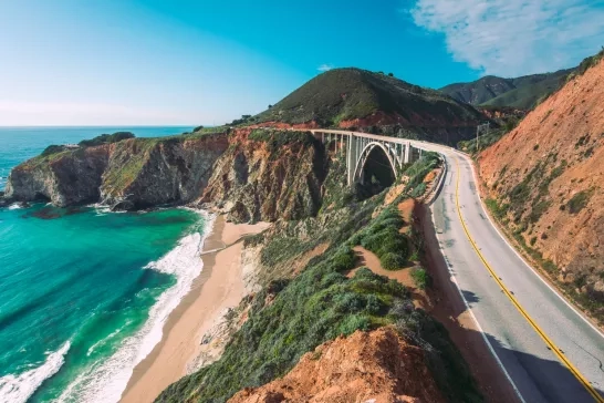 Cars drive on the Pacific Coast Highway at Big Sur in California, USA