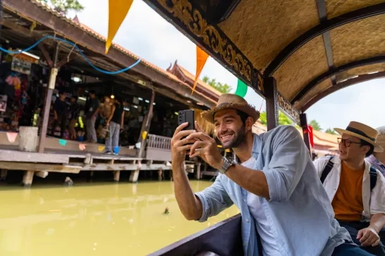man taking photo on his phone in Ayutthaya Province, Thailand