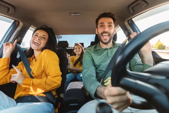 Happy family of three in car