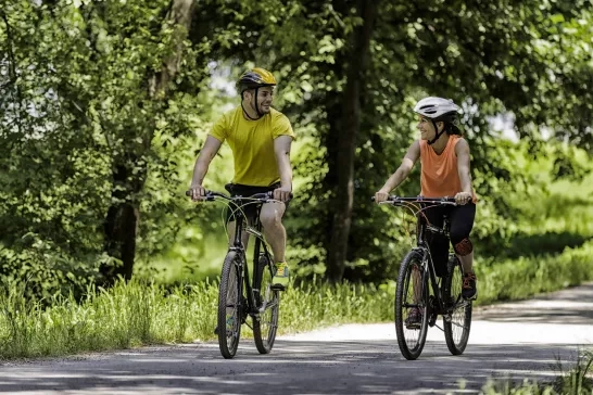 Two people cycling on a path