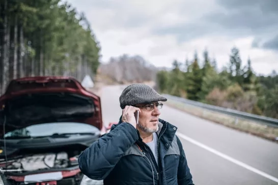 man-with-broken-down-car-calling-for-roadside-asssitance