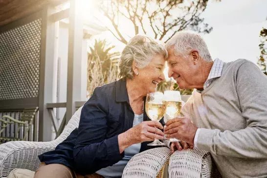 Elderly couple celebrating with champagne