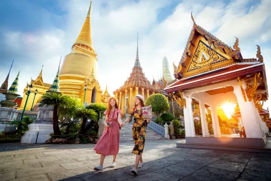 2 people walking in Thailand temple