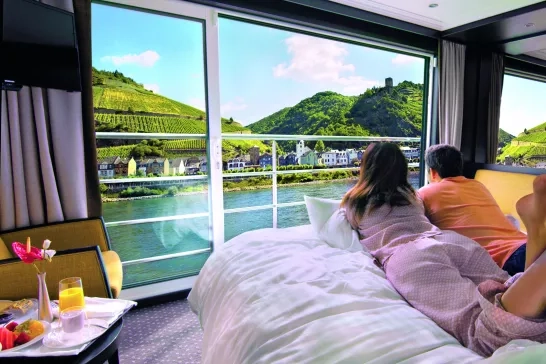 Couple admiring the view of their stateroom onboard Avalon Waterways